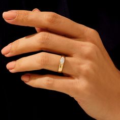 a woman's hand with a diamond ring on it