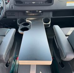 the interior of a car with two speakers and a table in the back seat area