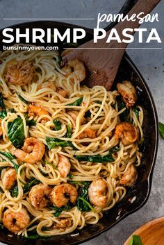 pasta with shrimp and spinach in a skillet