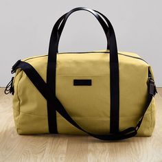 Part of our exclusive west elm Travel Collection, this lightweight, streamlined duffle bag is perfectly sized for short solo trips or weekends away. It has a removable shoulder strap and secures to our Hardside Spinner Luggage (sold separately) to make traveling in style easy. 27"w x 7.5"d x 15.75"h. Capacity: 50L. Nylon (Black) or polyester (Gray, Pale Pink) body. Bicast leather handles. Removable, adjustable shoulder strap. Large padded pocket for laptops or tablets. Zipper pocket. Perfect for Modern Everyday Duffle Bag With Double Handle, Modern Leather Duffle Bag With Double Handle, Modern On-the-go Travel Bag With Double Handle, Daily Use Leather-lined Rectangular Duffle Bag, Hardside Spinner Luggage, Leather Duffle Bag With Zipper Pocket, Rectangular, Spinner Luggage, Pink Body, Travel Collection