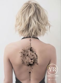 a woman with a lion tattoo on her back