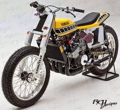 a yellow and black motorcycle parked on top of a white floor