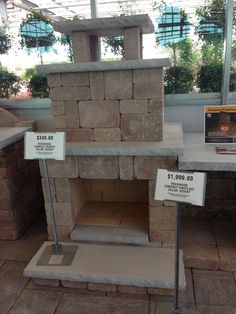 a stone oven with two signs on the side of it and another sign in front of it