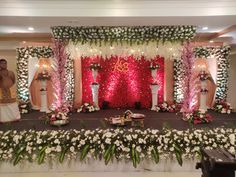 a mandap decorated with flowers and greenery