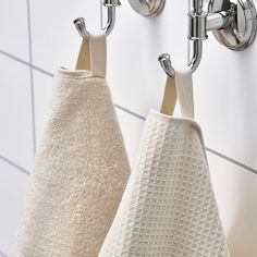 two towels hanging on the wall next to each other