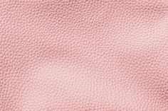 the texture of pink leather is shown in close up, as if it were made from natural materials