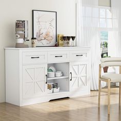 a white cabinet with open doors and drawers in a living room next to a window