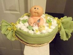 there is a cake that looks like a baby in a basket with flowers on it