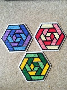 four different colored hexagons sitting on top of a table