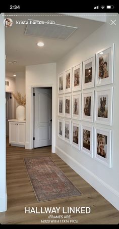 a hallway with pictures on the wall and a rug in front of an open door