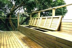 a wooden bench sitting on top of a wooden deck