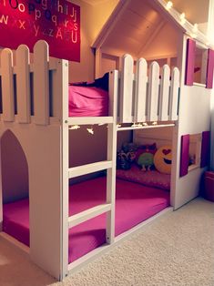 a child's bedroom with bunk beds made out of wood and pink carpeting