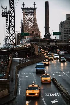 cars are driving down the street in front of the eiffel tower