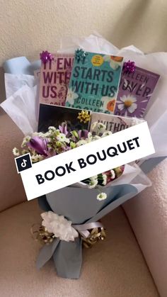 a bouquet of flowers sitting on top of a couch with the words book bouquet over it