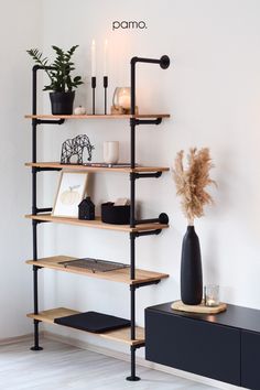 a shelf with some plants and candles on it