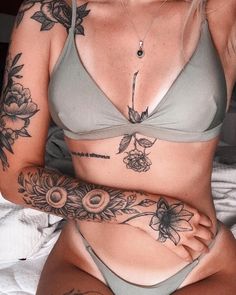 a woman with tattoos on her arm and chest