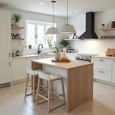 a kitchen with two stools and an island in front of the stove top oven