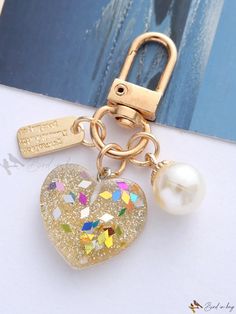 a key chain with a heart shaped charm attached to it