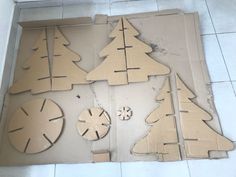 several pieces of cardboard cut out to look like christmas trees