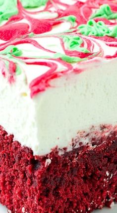 a piece of red velvet cake with white frosting and green sprinkles