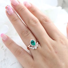 This simply stunning and gorgeous emerald ring bridal set features an oval shape green emerald engagement ring and a large 7 diamond u-shaped wedding band to create a timelessly elegant look. Adore your future bride with this halo style emerald diamond ring stack. It can be made in your choice of platinum or 18k or 14k yellow, rose, or white gold. ** The hand model's ring size is US ring size 6.25 Jewelry Information Engagement Ring: Center Stone:* Conflict Free Cultured Emerald (lab grown in th Emerald Cut Stackable Emerald Rings For Wedding, Wedding Stackable Emerald Rings With Emerald Cut, Stackable Oval Emerald Wedding Ring, Oval Stackable Emerald Wedding Ring, Halo Oval Ring, Diamond Ring Stack, Green Emerald Engagement Ring, Rose Gold Emerald Ring, Green Engagement Rings