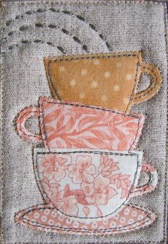 three coffee mugs are stacked on top of each other in this hand embroidered design