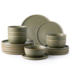 a set of green dinnerware on a white background