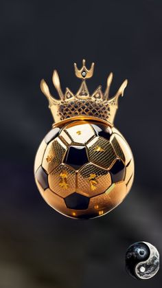 a golden soccer ball with a crown on top is floating in the air next to two silver balls