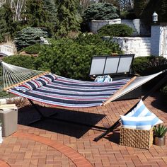 a hammock is sitting on the brick patio