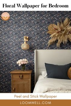 a bed room with a neatly made bed and wall paper