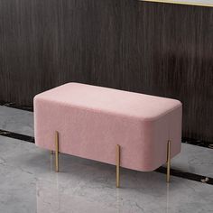 a pink bench sitting on top of a marble floor