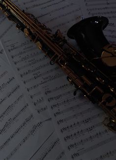 a saxophone sitting on top of sheet music