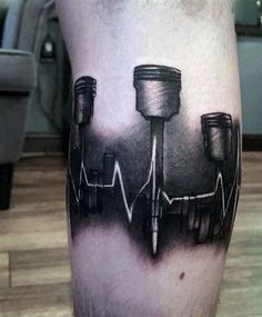 a man's leg with a black and white tattoo on it that has an image of medical equipment