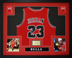 an autographed michael jordan jersey is displayed in a black frame with the number 23 on it