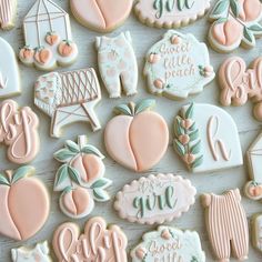 many decorated cookies on a table with words and symbols in the shape of hearts, peaches, etc