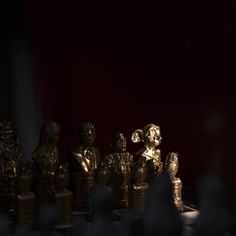 a chess board with golden figurines on it