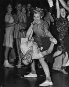 an old black and white photo of people dancing