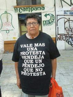 an older woman wearing a black shirt with words on it