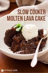 a white bowl filled with chocolate cake and ice cream on top of a wooden table