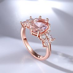 This enchanting piece features a stunning oval-cut morganite as the center stone, radiating beauty and sophistication. Adorning the sides of the main stone are clusters of brilliant white stones, adding a touch of sparkle and enhancing its timeless appeal. Crafted with meticulous attention to detail, this ring captures the essence of refined luxury. The soft, blush-pink hue of the morganite exudes a sense of romance and tenderness, making it a perfect choice for expressing love and devotion. The delicate arrangement of the white stones creates a harmonious balance, accentuating the brilliance of the main stone and illuminating the wearer's hand with a captivating glow. Indulge in the allure of this morganite oval cut ring, a testament to the everlasting beauty of fine jewelry.Carat Weight: Rose Gold Oval Morganite Topaz Ring, Rose Gold Oval Crystal Ring With Prong Setting, Rose Gold Oval Cluster Ring, Oval Rose Gold Crystal Ring With Accent Stones, Oval Rose Gold Cluster Ring, Oval Rose Gold Cluster Ring With Center Stone, Expressing Love, Oval Cut Ring, Divine Love