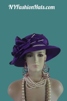 Women's Couture Designer Purple And White Brim Fashion Holiday Dress Hat. This Formal Wedding Hat Is Trimmed With A Large Purple Satin Rosette Bow Enhanced With Dark Purple Rhinestones. Satin Fabric Flowers With Dark Purple Rhinestones And White Encased Clear Rhinestone Stems Are Placed Next To The Bow. White Encased Clear Rhinestones Encircle The Crown Of This Beautiful Hat. This Elegant Dress Hat Will Make A Fashion Statement. This Statement Hat Is Custom Made And Designed By NY Fashion Hats Couture Millinery Headwear Apparel. This Hat Is Suited For Weddings, Brides, Mother Of The Bride, Church, Temple, Sabbath, Formal Affairs, Horse Races And Special Occasion Events And Gatherings. This bespoke premium quality dress hat is suited for Winter Fall And Early Spring. Material: Satin Head Si Fitted Cap Mini Hat For Wedding, Wedding And Kentucky Derby Costume Cap, Elegant Spring Bonnet, Brimmed Top Hat For Wedding, Fitted Cap For Wedding, Elegant Fitted Sun Hat For Wedding, Elegant Spring Cap Costume Hat, Elegant Spring Costume Cap, Elegant Fitted Summer Bonnet