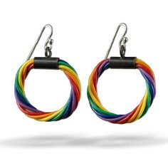 two pairs of multicolored hoop earrings with black metal hooks on white background, side by side