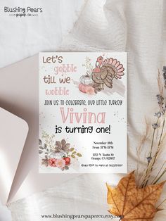 an image of a thanksgiving card with turkeys and leaves on the table next to it