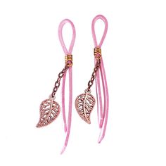 pair of pink cord earrings with heart shaped charms on the end and chain attached to each ear