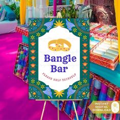 a sign that says bangle bar on it in front of some colorful fabric items