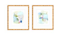 two framed art pieces on a wall with bamboo frame and the same painting in different colors