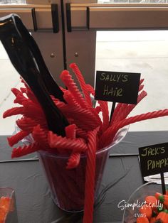 carrots are arranged in a bucket with signs on them