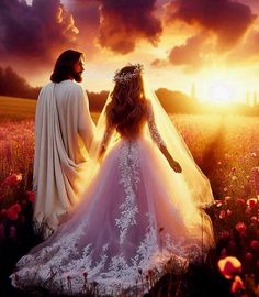 a man and woman in wedding gowns walking through a field at sunset with the sun behind them