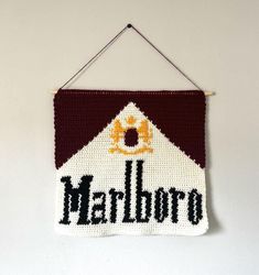 The Marlboro crochet pattern is made for advanced beginners to intermediate crochet artists. I highly suggest some prior knowledge of basic crochet techniques (single crochet, turning the work, etc). This pattern includes helpful instructions to start, a color block pattern, and a graph pattern as well. It also includes instructions on how to finish off with a border (if you want to) and mounting the tapestry as well. Just a note, this is written in US terminology, but you just need to know one Simple Tapestry Crochet, Crochet Tapestry Pattern, Simple Tapestry, Crochet Wall Hanging, Tapestry Pattern, Color Block Pattern, Crochet Wall Hangings, Tapestry Crochet Patterns, Basic Crochet