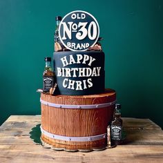 a birthday cake made to look like an old no 30 brand sign on top of a barrel